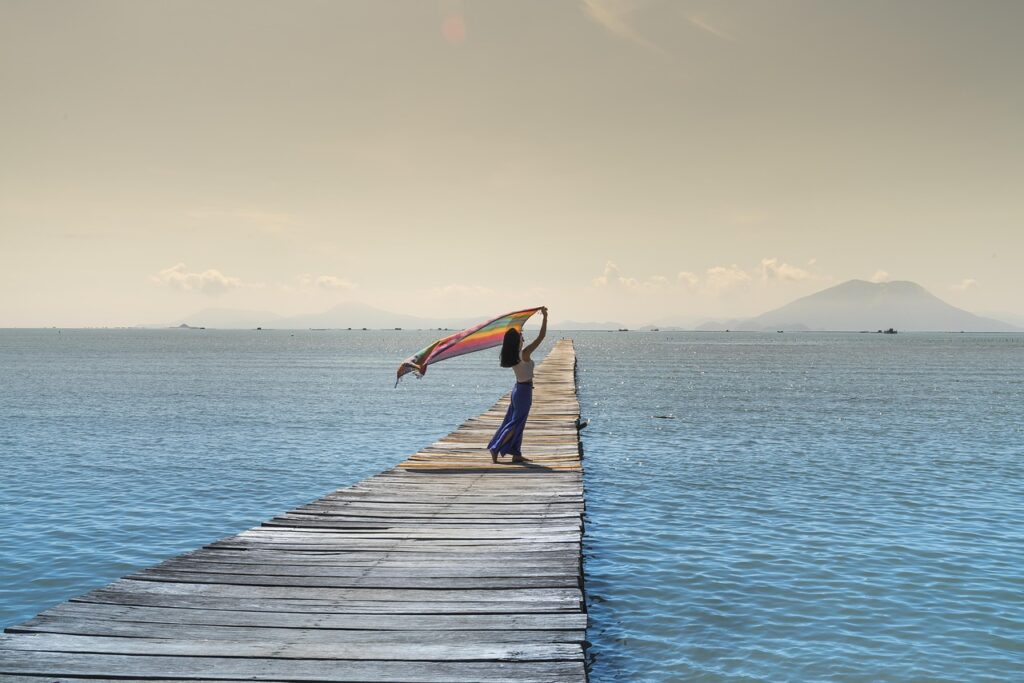 Woman on a jetty by the sea